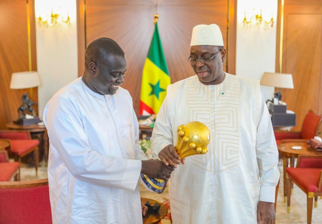 With his excellency Macky Sall, - holding the African Cup of Nations 2022